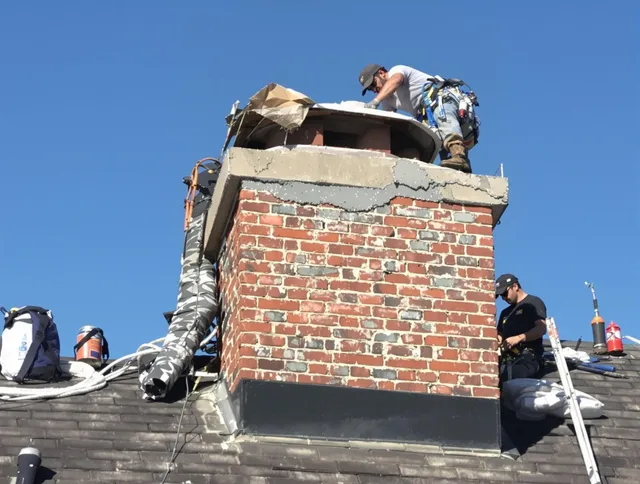 Norwell Chimney Sweep installing a custom chimney crown in Norwell, MA