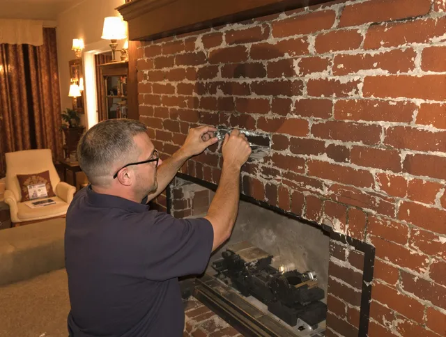 Norwell Chimney Sweep expert fixing a fireplace in Norwell, MA